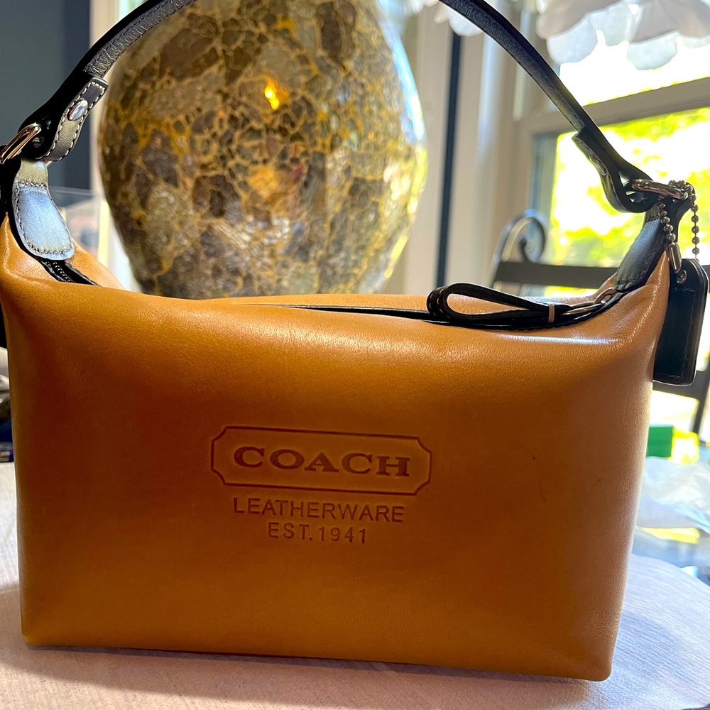 Here I have a original small coach bag it’s very nice and simple tan bag !